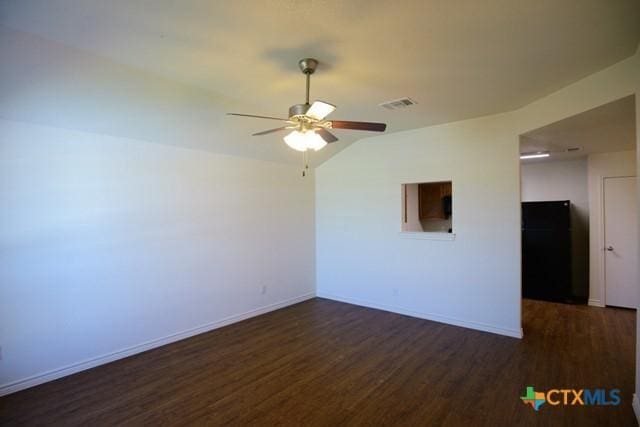 spare room featuring ceiling fan and dark wood-type flooring