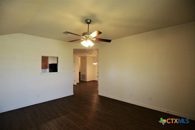 spare room featuring ceiling fan and dark wood-type flooring