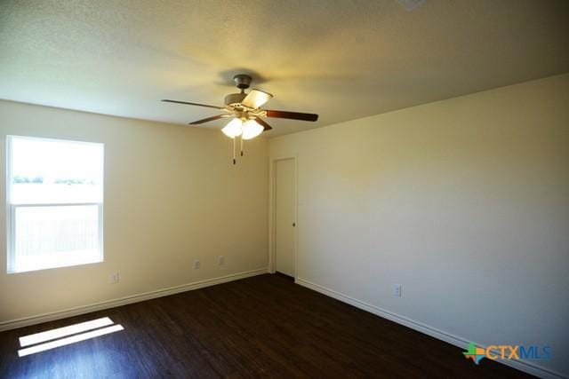 empty room featuring dark hardwood / wood-style floors and ceiling fan