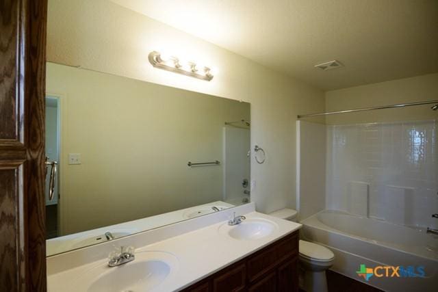 full bathroom featuring shower / tub combination, vanity, and toilet