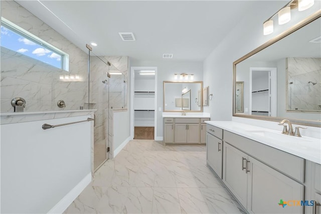 bathroom with a sink, a marble finish shower, marble finish floor, and visible vents