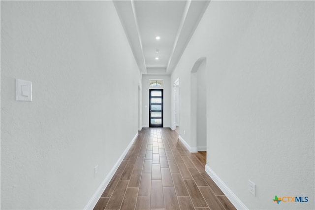 hall with recessed lighting, baseboards, arched walkways, and wood tiled floor