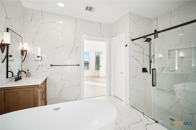 bathroom featuring vanity and separate shower and tub