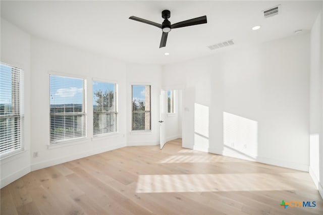 empty room featuring light wood-type flooring and ceiling fan