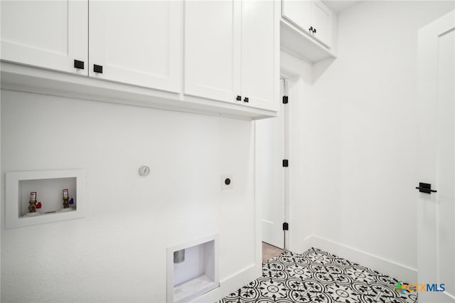 clothes washing area featuring cabinets, washer hookup, and hookup for an electric dryer