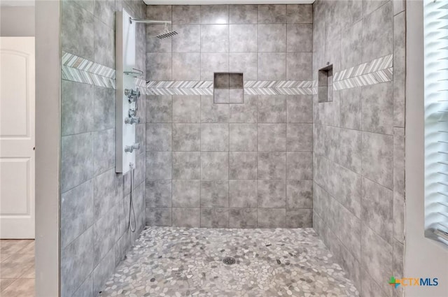 bathroom with a tile shower