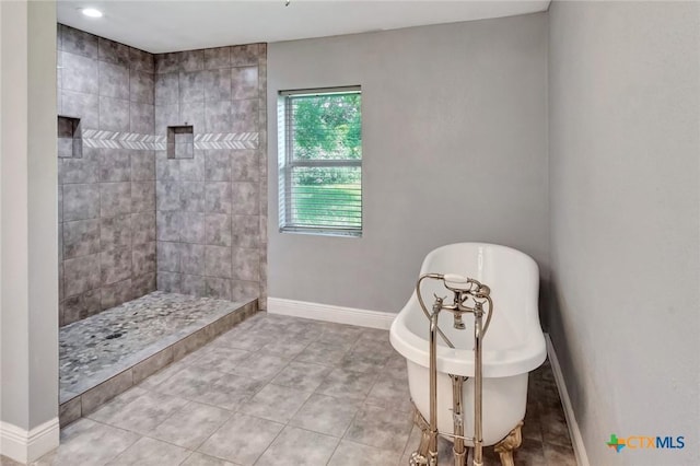 bathroom with independent shower and bath and tile patterned floors