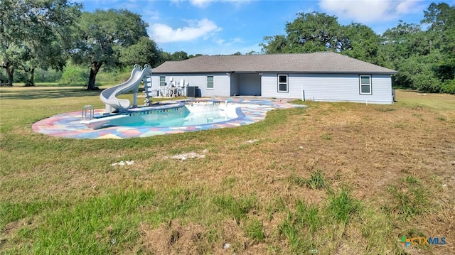 rear view of property featuring a yard and a patio area