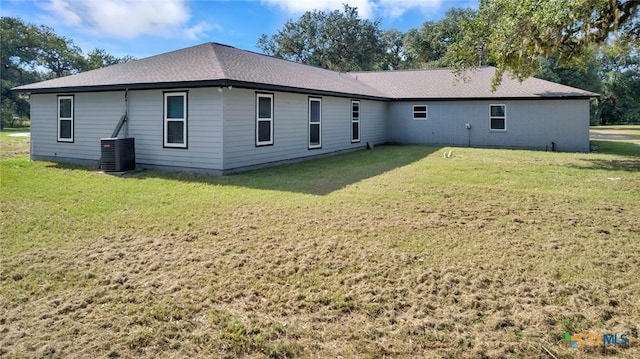 back of house with a yard and central AC unit