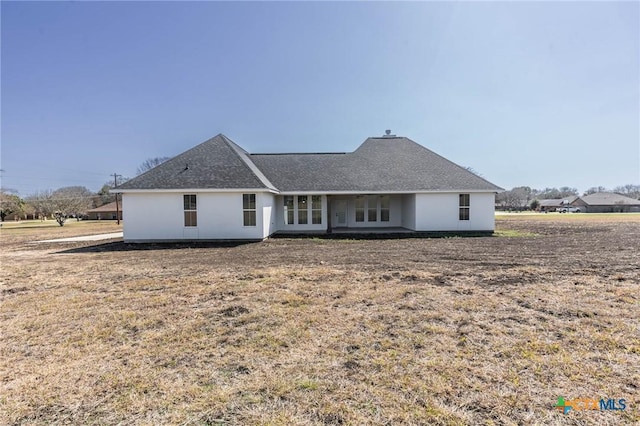 back of house with a shingled roof