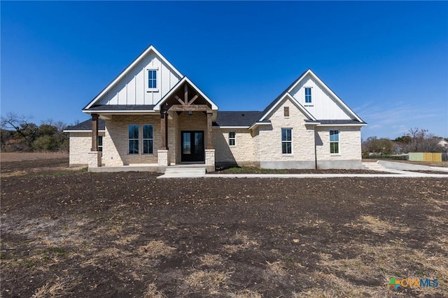 view of front facade featuring stone siding and board and batten siding