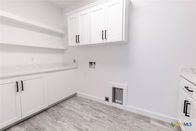 laundry area featuring baseboards, washer hookup, light wood-style flooring, cabinet space, and electric dryer hookup