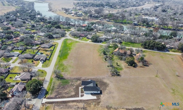 drone / aerial view with a water view and a residential view