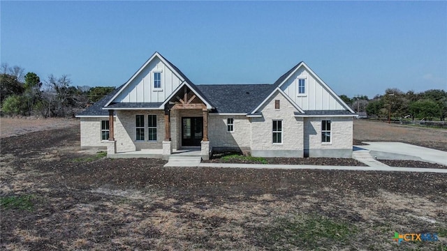 view of front of property featuring board and batten siding and stone siding