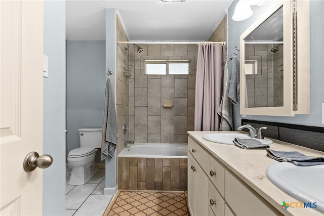 bathroom with a sink, tiled shower / bath, toilet, and double vanity