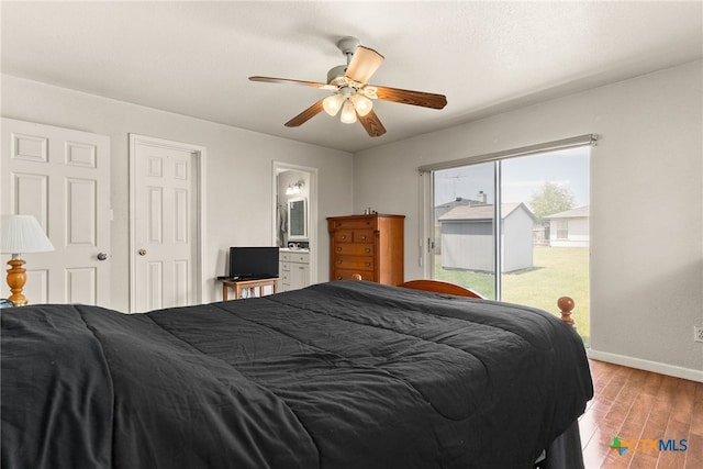 bedroom with ensuite bathroom, ceiling fan, wood finished floors, access to outside, and baseboards