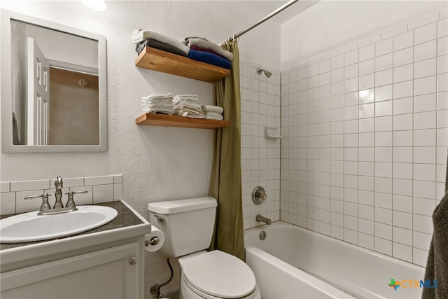 full bath with shower / tub combo, a textured wall, vanity, and toilet