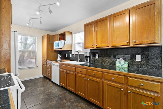 kitchen with white appliances, tile countertops, brown cabinets, a sink, and backsplash