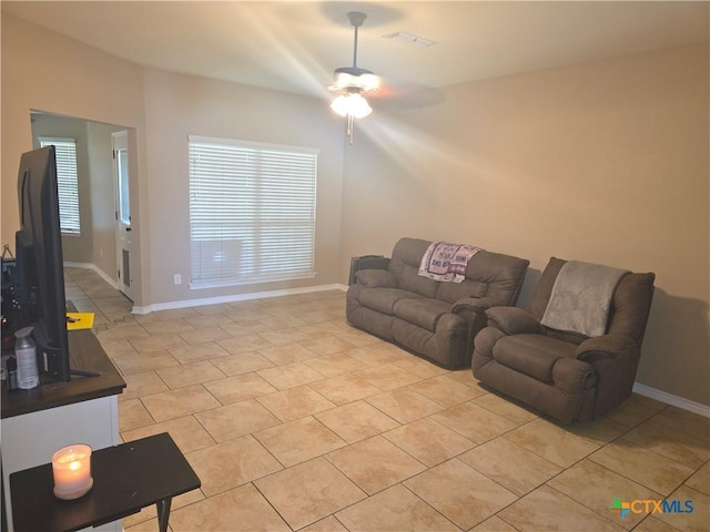 1212 Redstone Dr, Temple, TX 76502 - living room featuring a ceiling fan, light tile patterned floors, and healthy amount of natural light