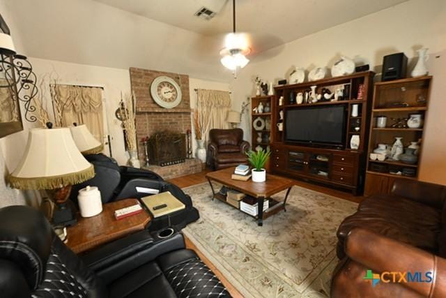 807 Hartrick Cir, Temple, TX 76502 - living room featuring a fireplace and wood finished floors