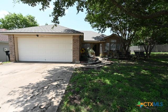 807 Hartrick Cir, Temple, TX 76502 - single story home with brick siding, driveway, and an attached garage