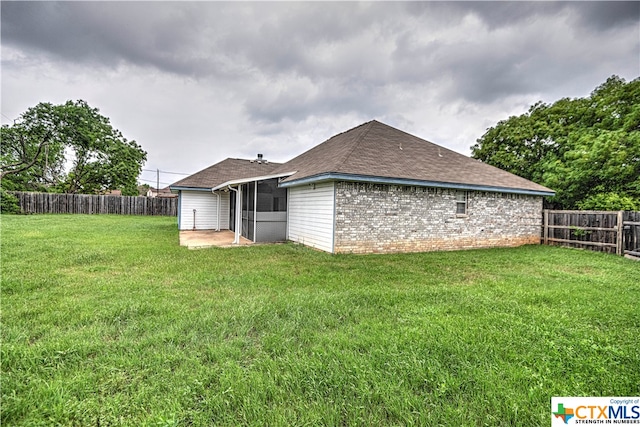 view of home's exterior with a patio and a yard