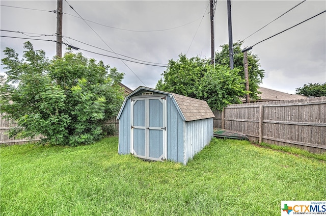 view of outbuilding featuring a yard