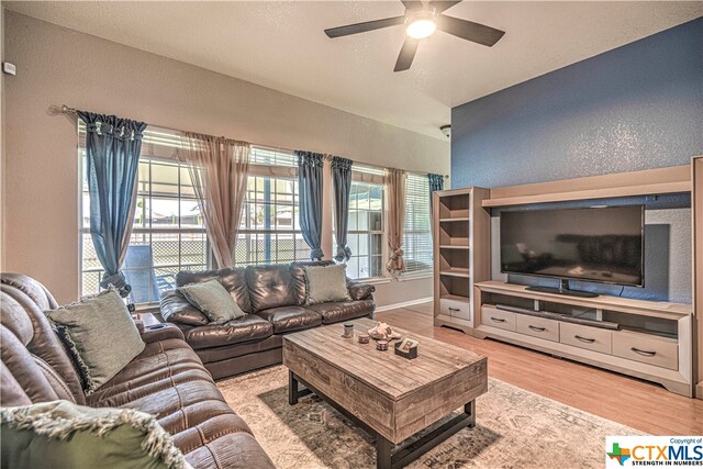 living room with ceiling fan and light wood-type flooring