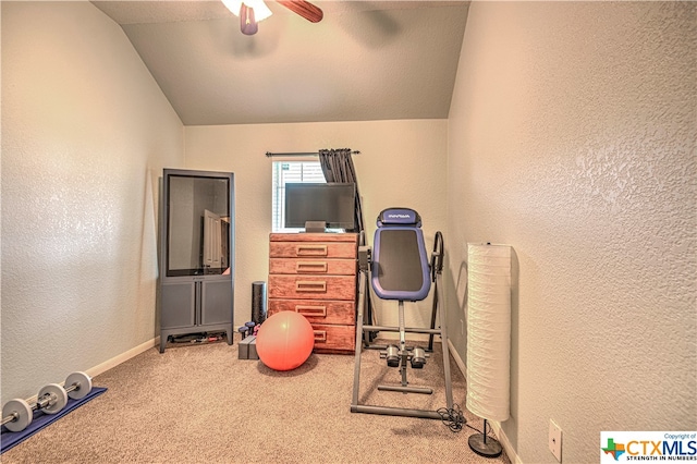 workout room with a textured ceiling, carpet, ceiling fan, and vaulted ceiling