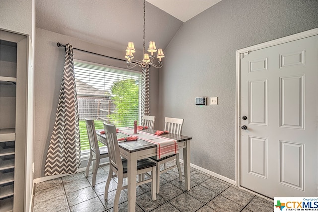 tiled dining room featuring vaulted ceiling and an inviting chandelier