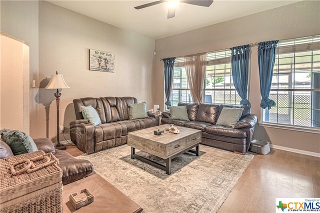 living room with wood-type flooring and ceiling fan