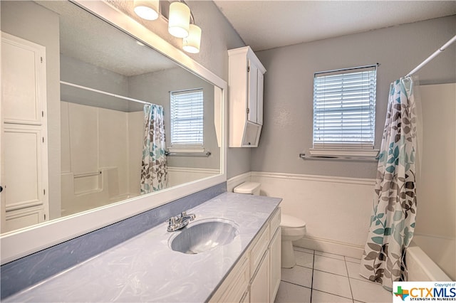 full bathroom featuring toilet, shower / bath combo, vanity, and tile patterned floors