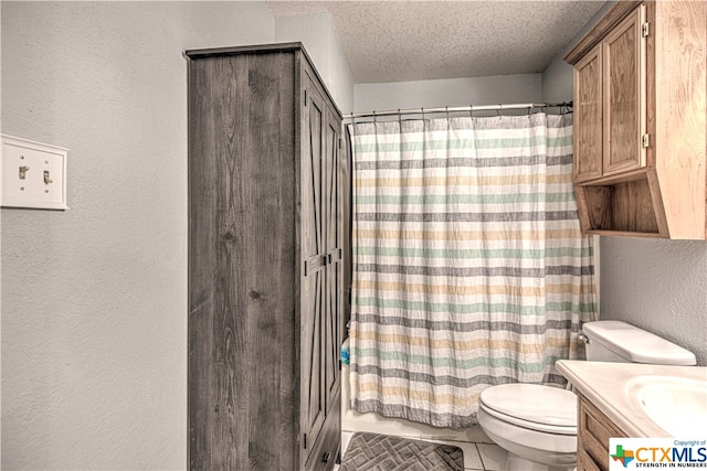 bathroom with toilet, tile patterned floors, curtained shower, a textured ceiling, and vanity