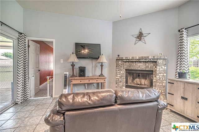 tiled living room featuring a fireplace