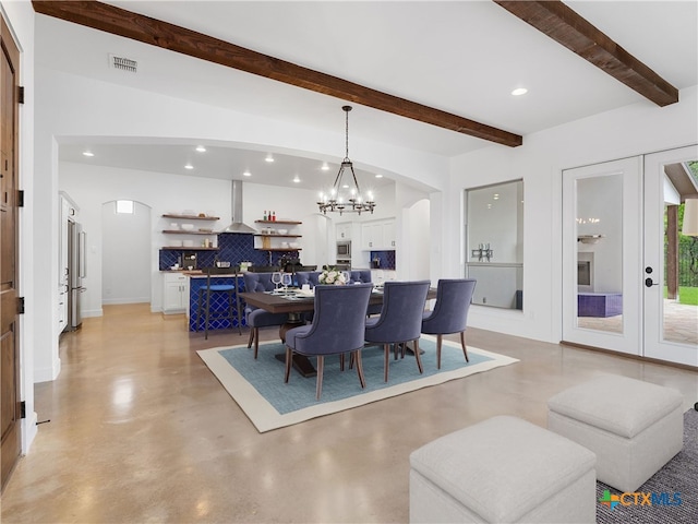 766 Mission Hts, New Braunfels, TX 78130 - dining room with arched walkways, beamed ceiling, recessed lighting, a chandelier, and concrete flooring