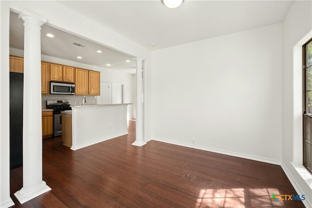 kitchen featuring dark hardwood / wood-style flooring, backsplash, appliances with stainless steel finishes, and sink