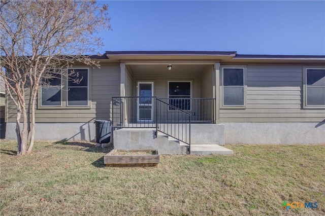 view of front of house with a front yard and covered porch