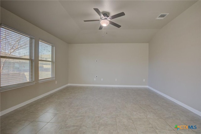 unfurnished room featuring vaulted ceiling, a ceiling fan, visible vents, and light tile patterned floors