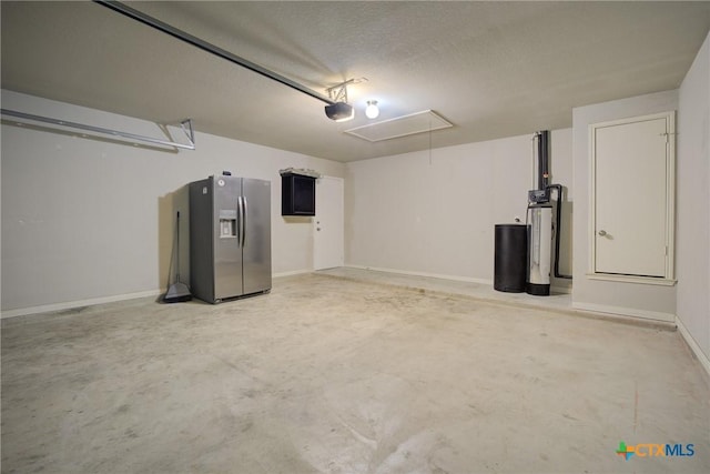 garage with baseboards, stainless steel fridge, and a garage door opener