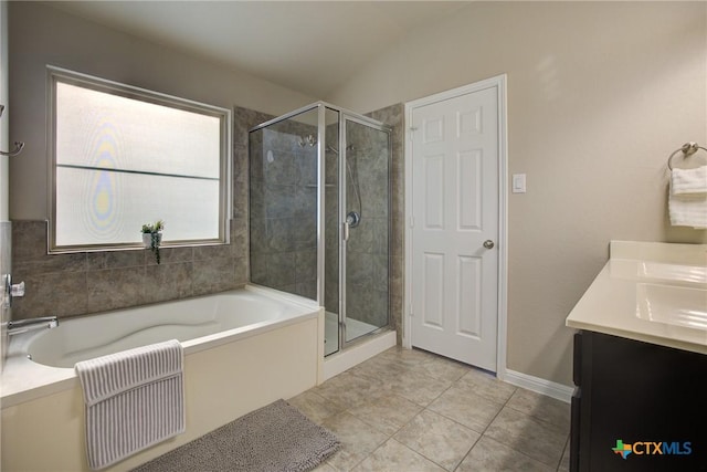 bathroom with tile patterned floors, a garden tub, vaulted ceiling, and a shower stall