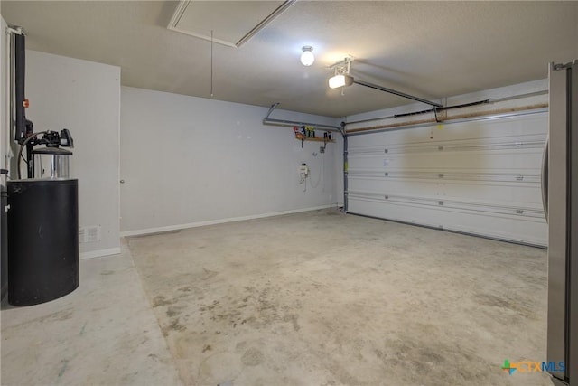 garage with a garage door opener and stainless steel refrigerator