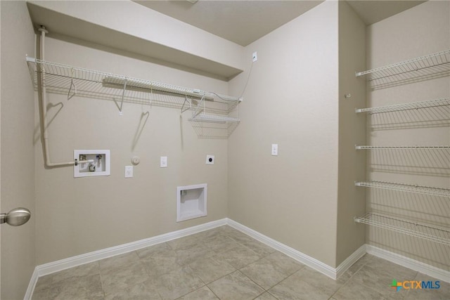 clothes washing area featuring laundry area, hookup for a gas dryer, baseboards, electric dryer hookup, and washer hookup