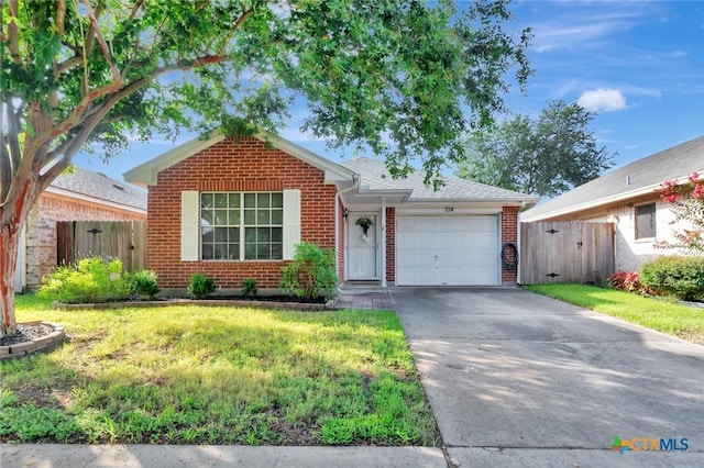 104 Majestic Ln, Victoria, TX 77904 - ranch-style house featuring an attached garage, brick siding, and driveway