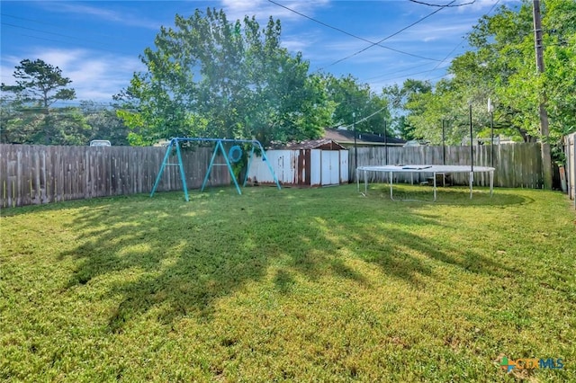 104 Majestic Ln, Victoria, TX 77904 - fenced backyard with a trampoline, a shed, and a playground