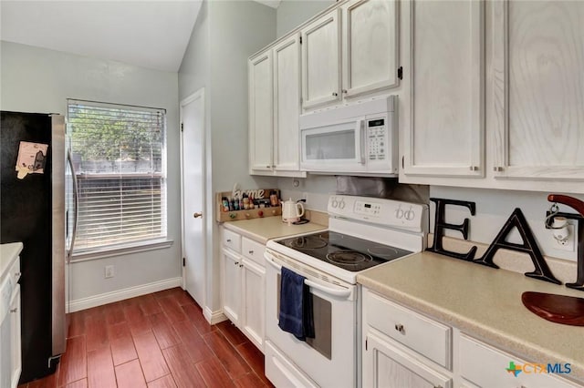 104 Majestic Ln, Victoria, TX 77904 - kitchen with white appliances, light countertops, white cabinets, dark wood-type flooring, and lofted ceiling