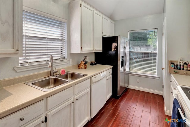 104 Majestic Ln, Victoria, TX 77904 - kitchen featuring white appliances, healthy amount of natural light, dark wood finished floors, white cabinets, and vaulted ceiling