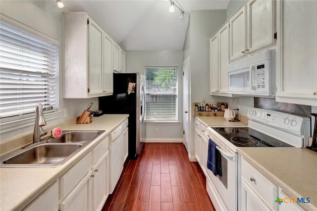 104 Majestic Ln, Victoria, TX 77904 - kitchen featuring white appliances, vaulted ceiling, dark wood-style floors, white cabinetry, and light countertops