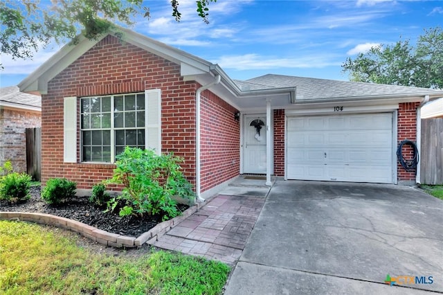 104 Majestic Ln, Victoria, TX 77904 - single story home featuring brick siding, concrete driveway, a garage, and a shingled roof