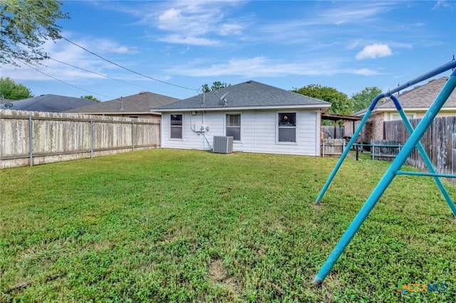 104 Majestic Ln, Victoria, TX 77904 - back of house with a playground, a fenced backyard, and a shingled roof