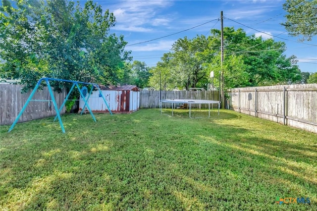 104 Majestic Ln, Victoria, TX 77904 - fenced backyard featuring a trampoline, a storage shed, and a playground